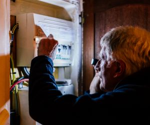 Man looking at circuit box image